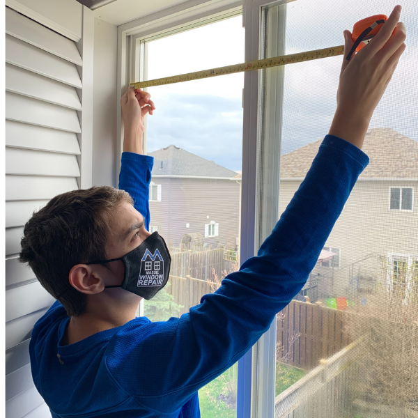 Employee installing a window